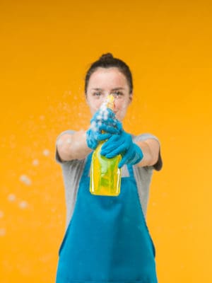 Female cleaning with spray