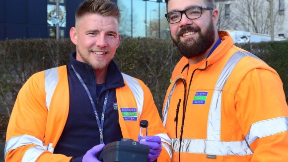 Two Severn Trent workers in orange high visibility, reflective jackets